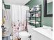 Bathroom featuring a shower with floral curtain, white vanity, and efficient storage at 1301 Pridgen Rd. # 903, Myrtle Beach, SC 29577