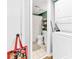 Bathroom with modern laundry appliances adjacent to sleek fixtures, and decorative shelving at 1301 Pridgen Rd. # 903, Myrtle Beach, SC 29577