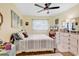 Comfortable bedroom with ceiling fan, a large window and a dresser at 1301 Pridgen Rd. # 903, Myrtle Beach, SC 29577