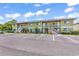 Multi-unit building featuring light green facade, white staircases, and ample parking space at 1301 Pridgen Rd. # 903, Myrtle Beach, SC 29577