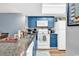 Well-lit kitchen with granite countertops, and white appliances at 1301 Pridgen Rd. # 903, Myrtle Beach, SC 29577