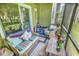 Inviting screened patio with comfortable seating, storage and potted plants at 1301 Pridgen Rd. # 903, Myrtle Beach, SC 29577