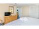 Bedroom view showcasing the dresser, TV, and mirrored closet, ideal for storage at 1304 N Ocean Blvd. # 200, Myrtle Beach, SC 29577