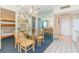 Dining area featuring a glass table and seating for six, adjacent to kitchen and bunk beds at 1304 N Ocean Blvd. # 200, Myrtle Beach, SC 29577