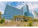 Exterior view of building with blue-tinted windows and ocean view at 1304 N Ocean Blvd. # 200, Myrtle Beach, SC 29577