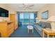Comfortable living room with ocean view, plush furniture, and a ceiling fan for a relaxing ambiance at 1304 N Ocean Blvd. # 200, Myrtle Beach, SC 29577