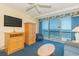 Living room featuring ocean views, TV, ceiling fan, and an armoire cabinet at 1304 N Ocean Blvd. # 200, Myrtle Beach, SC 29577