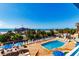 Elevated view featuring a blue pool surrounded by lounge chairs and a clear view of the beach and pier at 1304 N Ocean Blvd. # 301, Myrtle Beach, SC 29577