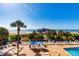 An elevated view shows a brick-lined pool area, filled with lounge chairs and views of the beach and pier at 1304 N Ocean Blvd. # 301, Myrtle Beach, SC 29577