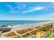 An ocean view with pier, restaurants, beach goers, and seating at 1304 N Ocean Blvd. # 505, Myrtle Beach, SC 29577