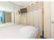 Well-lit bedroom featuring a full mirrored wall and closet with hanging TV at 1304 N Ocean Blvd. # 505, Myrtle Beach, SC 29577