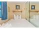 Comfortable bedroom featuring a queen bed with soft, white bedding and a mirrored wall at 1304 N Ocean Blvd. # 505, Myrtle Beach, SC 29577