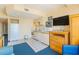 Compact kitchen with white cabinets, tile floor, and adjacent living area at 1304 N Ocean Blvd. # 505, Myrtle Beach, SC 29577