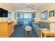 Comfortable living room with ocean views, blue carpet, and furniture at 1304 N Ocean Blvd. # S-201, Myrtle Beach, SC 29577