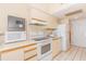Compact kitchen featuring white appliances and cabinets, with a convenient microwave at 1304 N Ocean Blvd. # S-307, Myrtle Beach, SC 29577