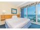 Comfortable bedroom with a king-sized bed and sliding glass doors offering stunning ocean views at 1304 N Ocean Blvd. # S-307, Myrtle Beach, SC 29577