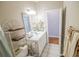 Bright bathroom features white vanity, open doorway and a decorative towel rack at 1427 Mcmaster Dr., Myrtle Beach, SC 29575