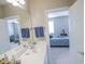 Bright bathroom with white vanity, open doorways leading to a bedroom and sitting area at 1427 Mcmaster Dr., Myrtle Beach, SC 29575