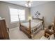Cozy bedroom featuring a wooden four-poster bed, neutral walls, and a bright window at 1427 Mcmaster Dr., Myrtle Beach, SC 29575