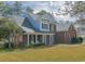 Charming two-story brick home featuring a welcoming front porch and well-manicured lawn at 1427 Mcmaster Dr., Myrtle Beach, SC 29575