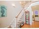Elegant foyer boasts a staircase and display cabinet on hardwood floors with natural light at 1427 Mcmaster Dr., Myrtle Beach, SC 29575