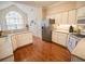 Bright kitchen features white cabinets, stainless steel appliances, and hardwood floors at 1427 Mcmaster Dr., Myrtle Beach, SC 29575
