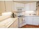 Efficient kitchen with white appliances and light countertops, ideal for cooking at 1427 Mcmaster Dr., Myrtle Beach, SC 29575