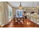 Elegant dining room featuring hardwood floors, a chandelier, large windows, and stylish curtains at 154 Harbor Oaks Dr., Myrtle Beach, SC 29588