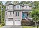 Charming home with gray siding, a blue front door, and a two-car garage, nestled among lush trees at 154 Harbor Oaks Dr., Myrtle Beach, SC 29588