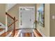 Welcoming foyer with hardwood floors, a white front door, and a painting, leading to a bright, inviting space at 154 Harbor Oaks Dr., Myrtle Beach, SC 29588