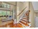 Bright foyer featuring hardwood floors, a staircase with wood and iron railings, and a glimpse into the living room at 154 Harbor Oaks Dr., Myrtle Beach, SC 29588