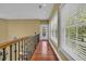 Hallway with natural light, hardwood floors, and a view of the outdoors through large windows at 154 Harbor Oaks Dr., Myrtle Beach, SC 29588