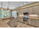 Well-lit kitchen with stainless steel appliances, light gray cabinetry, and granite countertops at 154 Harbor Oaks Dr., Myrtle Beach, SC 29588