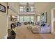 Spacious living room with high ceilings, a chandelier, large windows, and comfortable seating arrangements at 154 Harbor Oaks Dr., Myrtle Beach, SC 29588