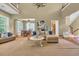 Open-concept living area with stylish furnishings, hardwood floors, and large windows for abundant natural light at 154 Harbor Oaks Dr., Myrtle Beach, SC 29588