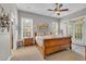 Bright main bedroom with a ceiling fan, ensuite bathroom, and balcony access at 154 Harbor Oaks Dr., Myrtle Beach, SC 29588