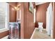 Cozy powder room featuring a dark vanity, textured wallpaper, and tiled floors at 154 Harbor Oaks Dr., Myrtle Beach, SC 29588