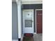Front door with white screen door and welcome mat at 1851 Colony Dr. # 5M, Surfside Beach, SC 29575