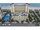 Aerial view of condo building with parking deck, dome feature, and beach access at 2000 N Ocean Blvd. # 1206, Myrtle Beach, SC 29577