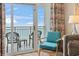 Balcony provides ocean views, dining chairs, and colorful floral drapes at 2000 N Ocean Blvd. # 1206, Myrtle Beach, SC 29577