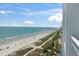 Balcony showcasing a pristine beach with blue skies and distant pier, providing breathtaking scenery at 2000 N Ocean Blvd. # 1206, Myrtle Beach, SC 29577