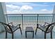Relaxing balcony featuring chairs and a table with ocean views and a sandy beach at 2000 N Ocean Blvd. # 1206, Myrtle Beach, SC 29577