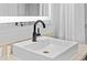 Bathroom vanity features a square sink, dark faucet, and neutral countertop with backsplash at 2000 N Ocean Blvd. # 1206, Myrtle Beach, SC 29577