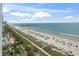 Scenic beach view with colorful umbrellas, clear waters, and the pier, offering a delightful seaside experience at 2000 N Ocean Blvd. # 1206, Myrtle Beach, SC 29577