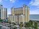 Stunning high-rise condo building with a yellow facade, offering beautiful ocean views and a convenient parking garage at 2000 N Ocean Blvd. # 1206, Myrtle Beach, SC 29577