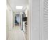 Bright hallway with white tile flooring leading to a bedroom at 2000 N Ocean Blvd. # 1206, Myrtle Beach, SC 29577