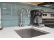 Close up of coffee maker and steel faucet with teal backsplash at 2000 N Ocean Blvd. # 1206, Myrtle Beach, SC 29577