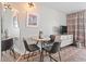 Open-concept living space shows a dining table, a television, and a mirror at 2000 N Ocean Blvd. # 1206, Myrtle Beach, SC 29577