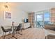 Living room showcases ocean views from balcony, a dining table, and a television at 2000 N Ocean Blvd. # 1206, Myrtle Beach, SC 29577