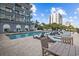 Pool deck view with lounge chairs for relaxing outdoors with building and ocean views at 2001 S Ocean Blvd. # 920, Myrtle Beach, SC 29577